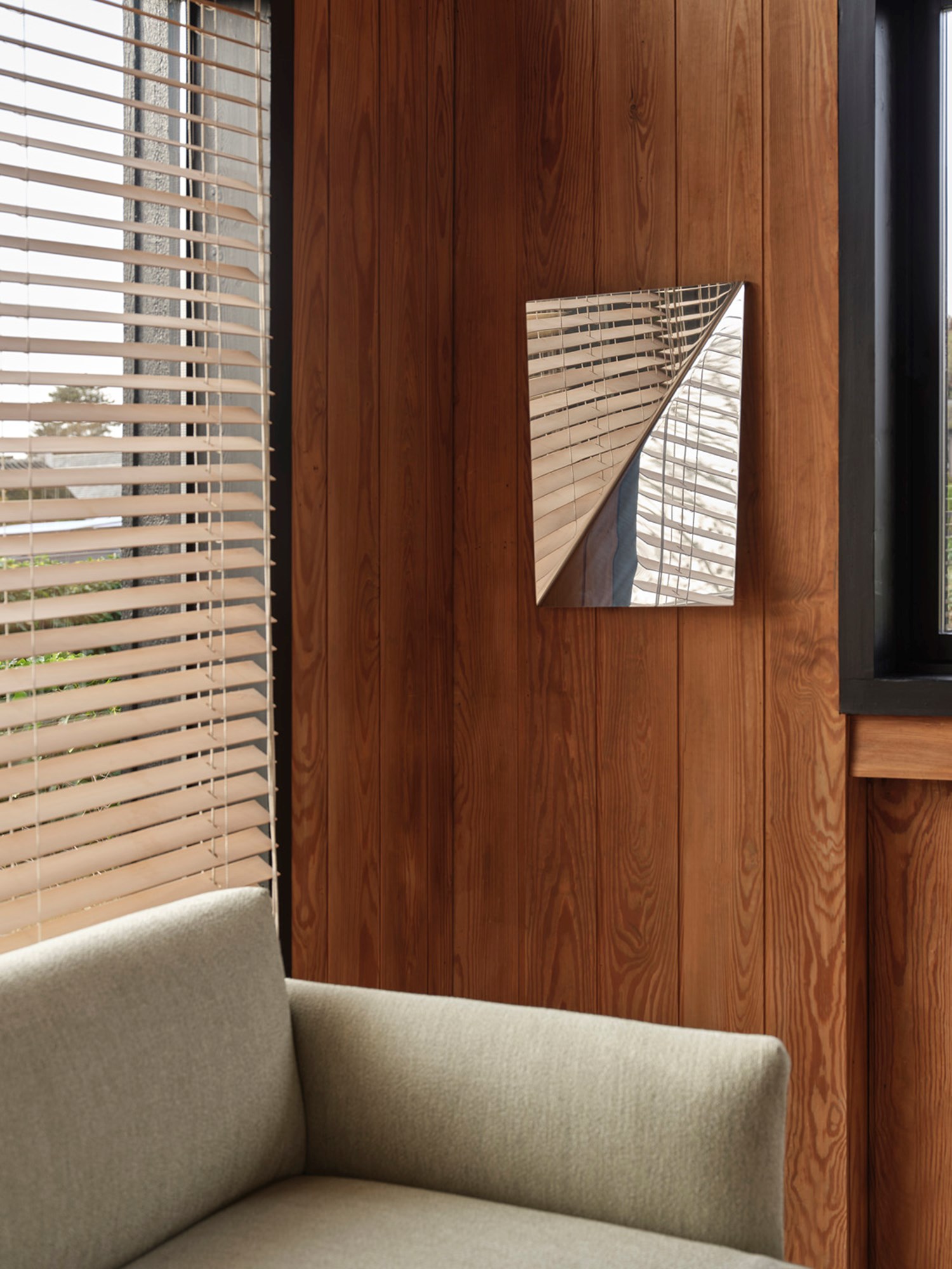 A sophisticated Outline Sofa styled with a sculptural Gaze Mirror.  A sophisticated Outline Sofa styled with a sculptural Gaze Mirror.