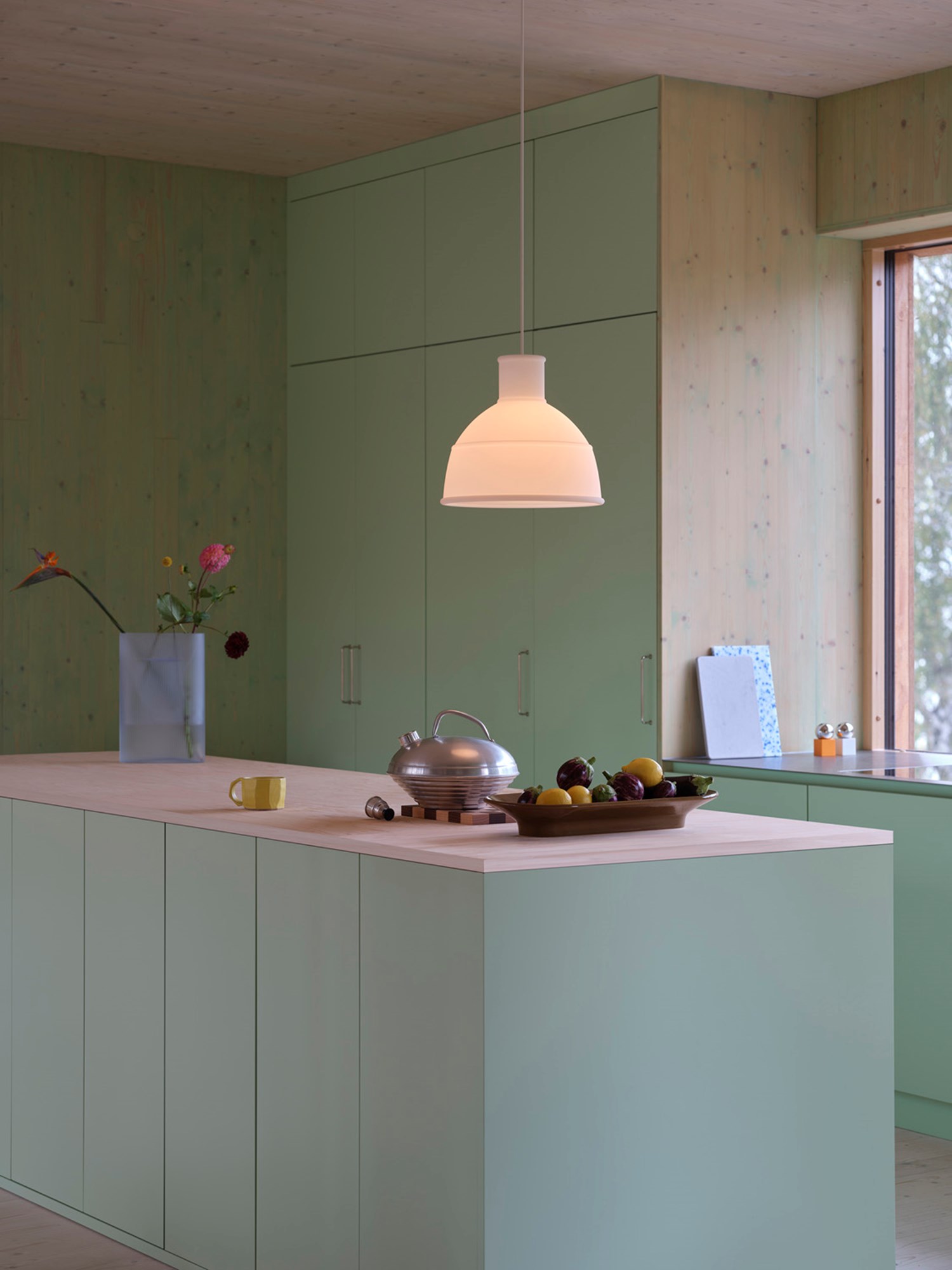 The Muuto Unfold Pendant Lamp in translucent white is paired with a light blue frosted glass Ridge Vase and a brown-green Mere Bowl. This stylish ensemble creates a harmonious, modern aesthetic, perfect for contemporary interiors seeking a blend of soft light and sculptural elegance. The Muuto Unfold Pendant Lamp in translucent white is paired with a light blue frosted glass Ridge Vase and a brown-green Mere Bowl. This stylish ensemble creates a harmonious, modern aesthetic, perfect for contemporary interiors seeking a blend of soft light and sculptural elegance.