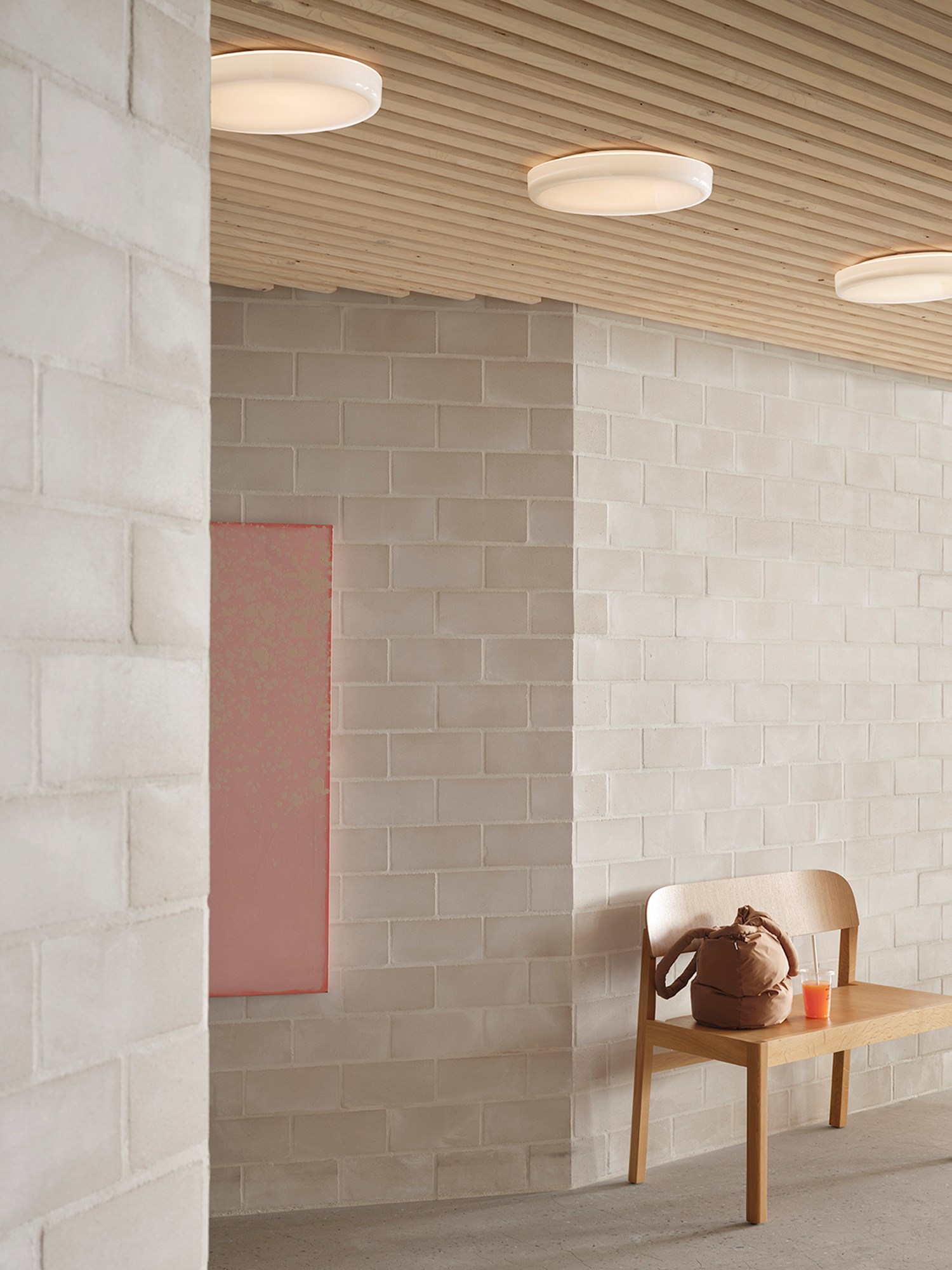 A round wall and ceiling lamp hanging above a workshop bench made of oak, creating a functional yet stylish setup. A round wall and ceiling lamp hanging above a workshop bench made of oak, creating a functional yet stylish setup.
