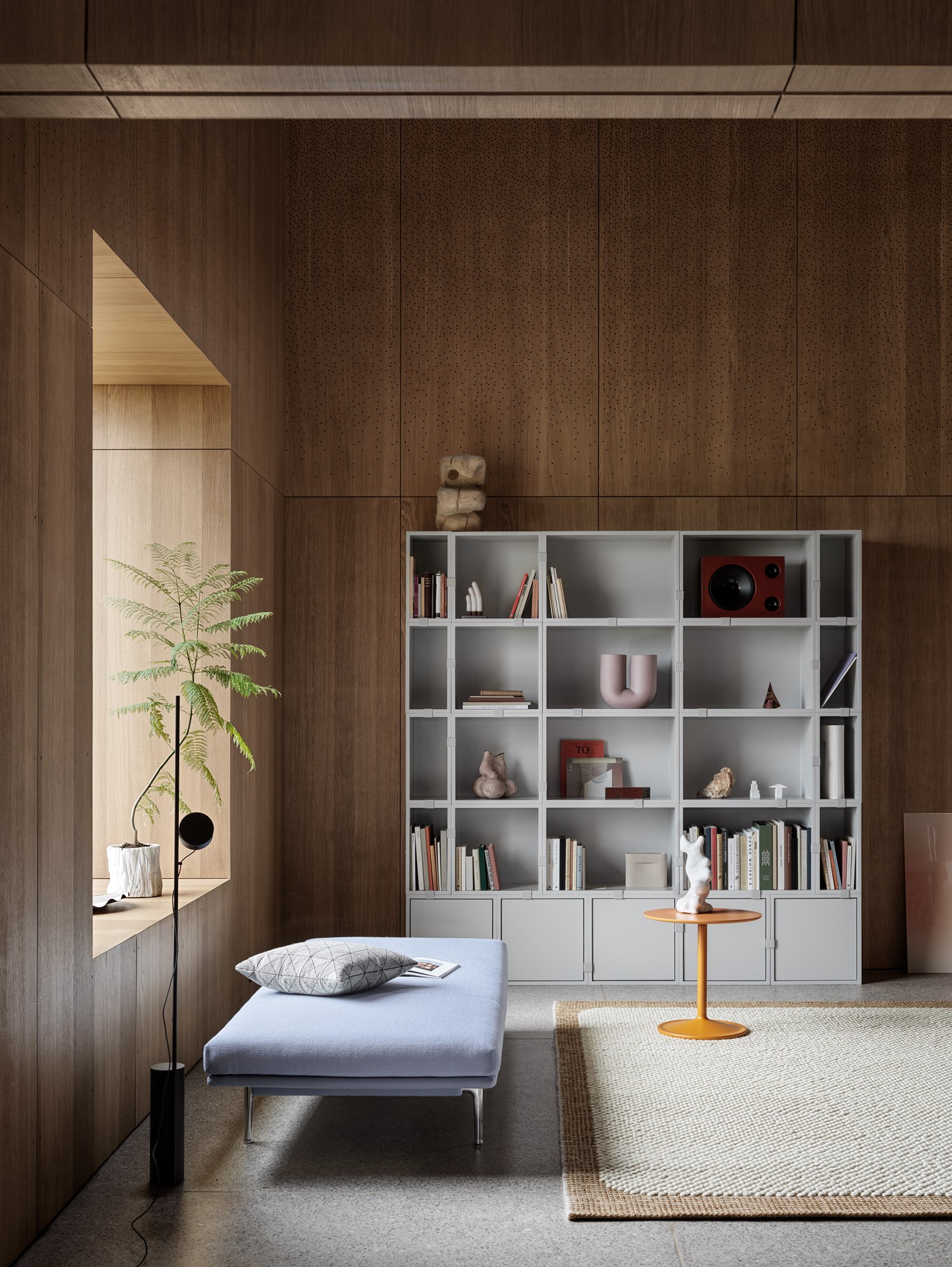 Outline Daybed, Stacked Storage System, Soft Side Table, Pebble Rug, Kink Vase Interior setting featuring Stacked Storage System in Grey, Outline Daybed in Vidar 723, Soft Side Table in Orange Ø48 H48, Pebble Rug in Burnt Orange and Kink Vase in Dusty Lilac. A colourful and contemporary composition by Muuto.