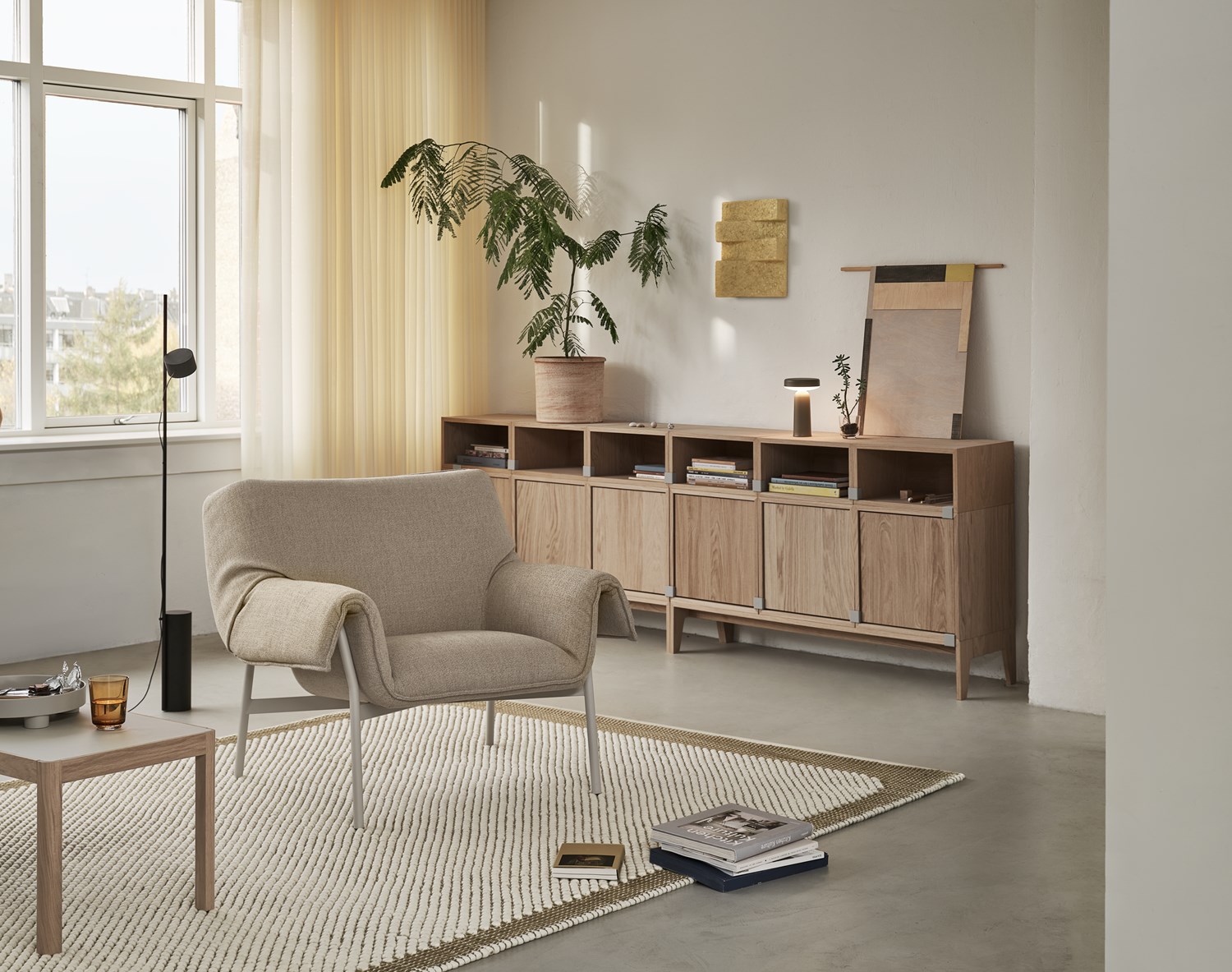 Wrap Lounge Chair in Ecriture 240/Grey, Pebble Rug 200x300 cm in Brown Green, Workshop Coffee Table in Warm Grey Linoleum/Oak, Stacked Storage System in Oak, Ease Portable Lamp in Taupe, Platform Tray in Grey, Raise Glass in Burnt Orange, Post Floor Lamp in Black Wrap Lounge Chair in Ecriture 240/Grey, Pebble Rug 200x300 cm in Brown Green, Workshop Coffee Table in Warm Grey Linoleum/Oak, Stacked Storage System in Oak, Ease Portable Lamp in Taupe, Platform Tray in Grey, Raise Glass in Burnt Orange, Post Floor Lamp in Black