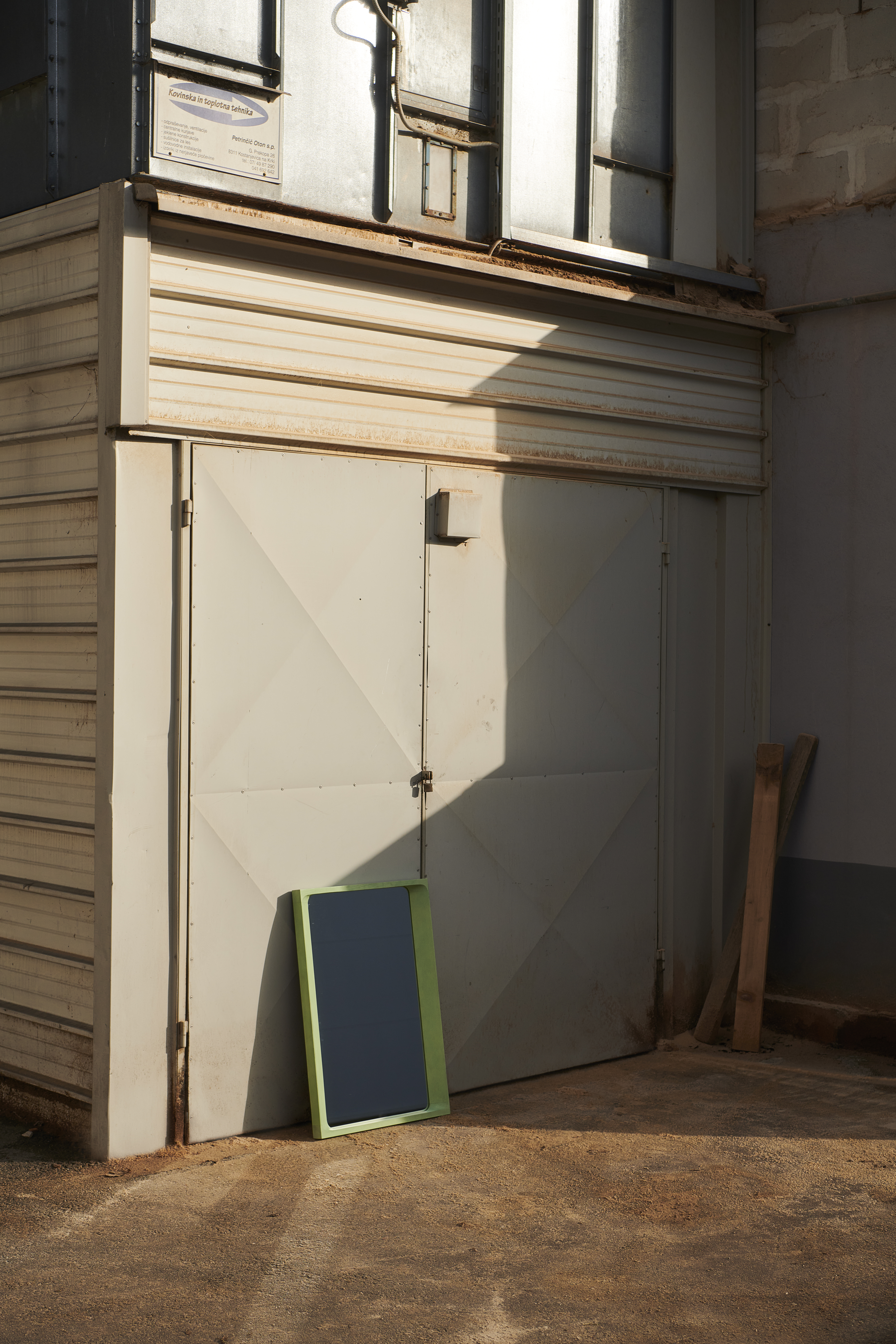 Factory scene showing the production or assembly of the Muuto Arced Mirror, highlighting craftsmanship, materials, and industrial surroundings.