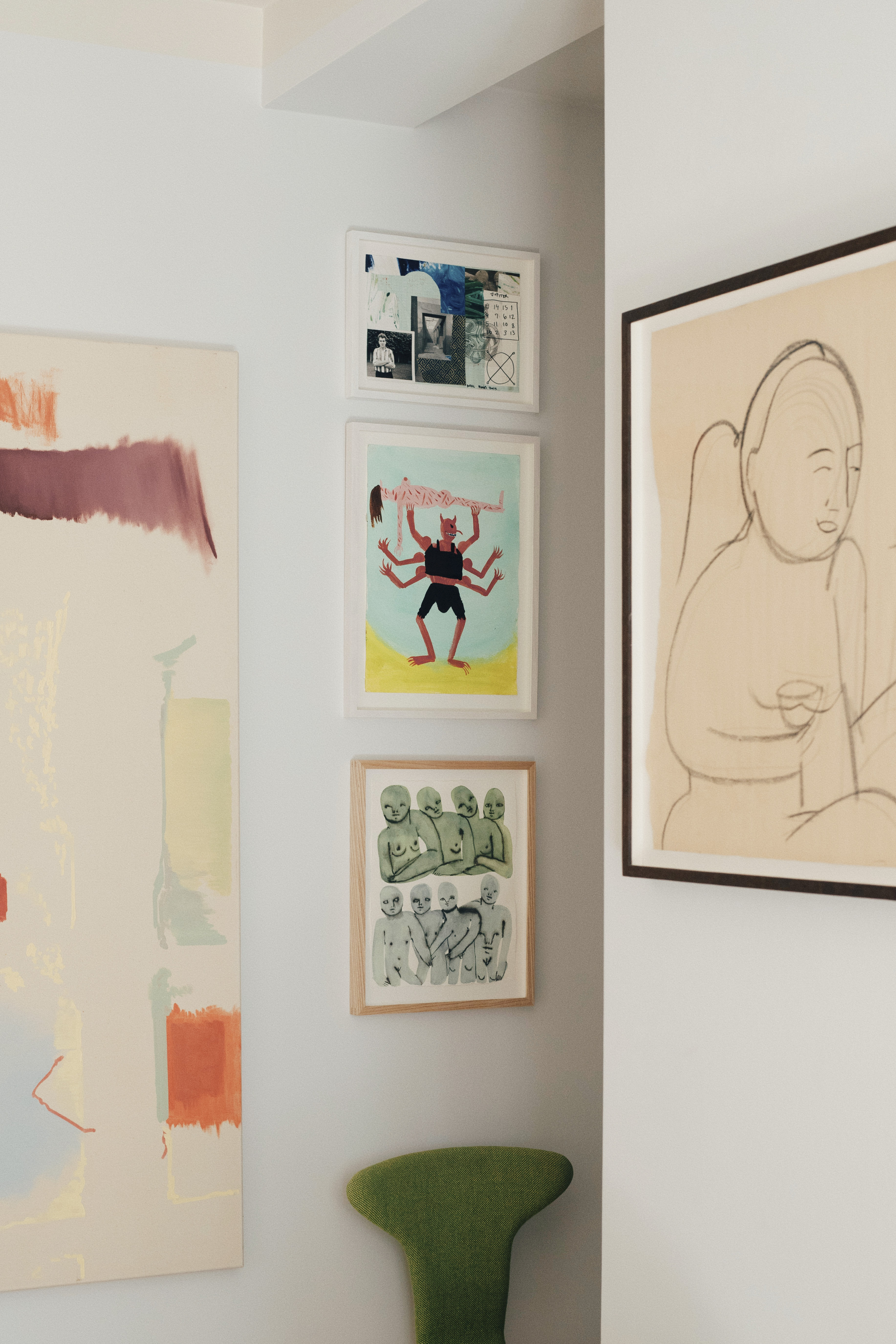 A view of a wall in Michael Schneider’s home featuring framed artwork, styled alongside warm materials in a minimal interior setting.
