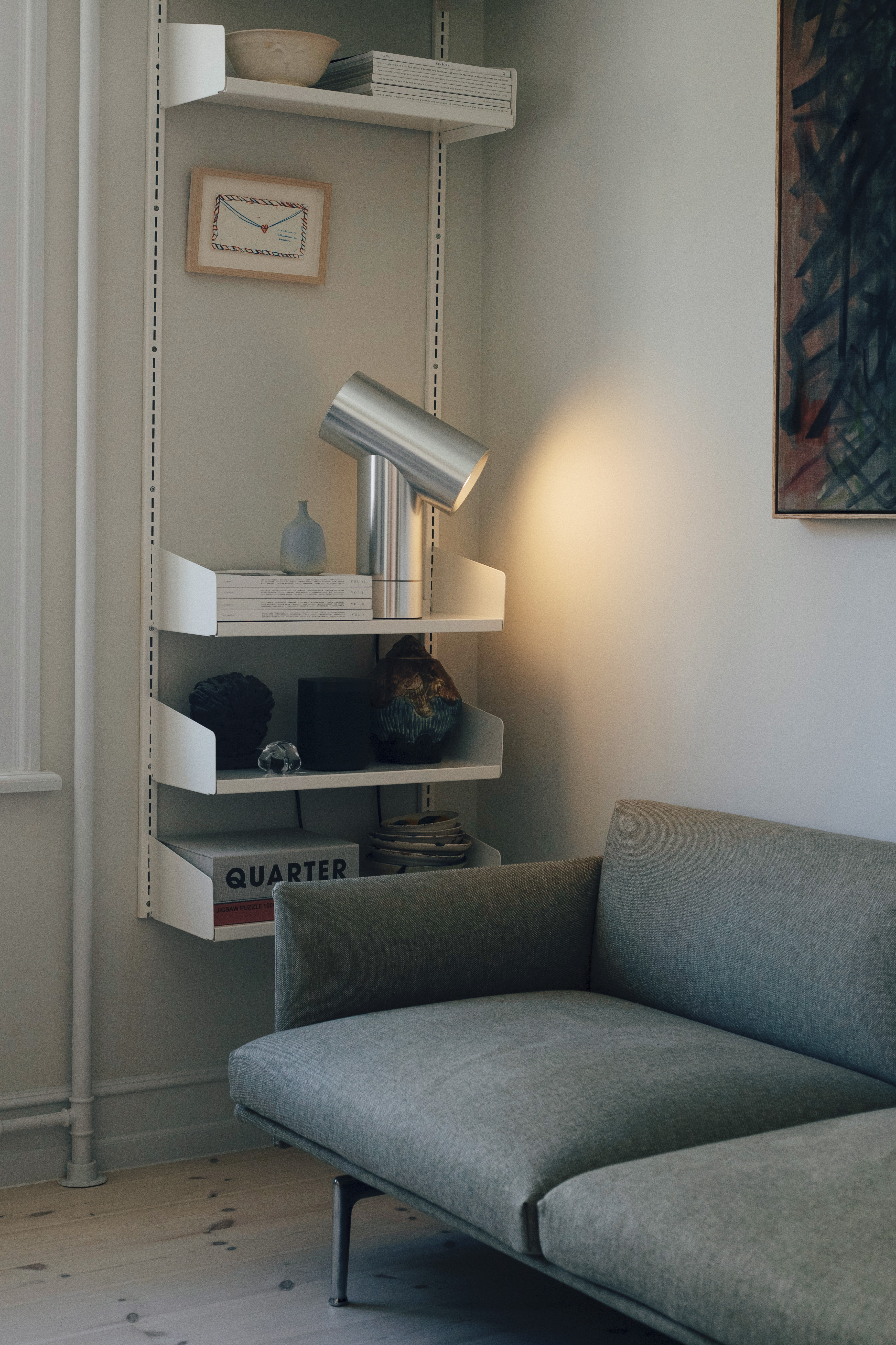 The Outline Sofa and Beam Table Lamp by Muuto styled together in Michael Schneider’s home, creating a warm and minimal living space with thoughtful details and soft lighting.