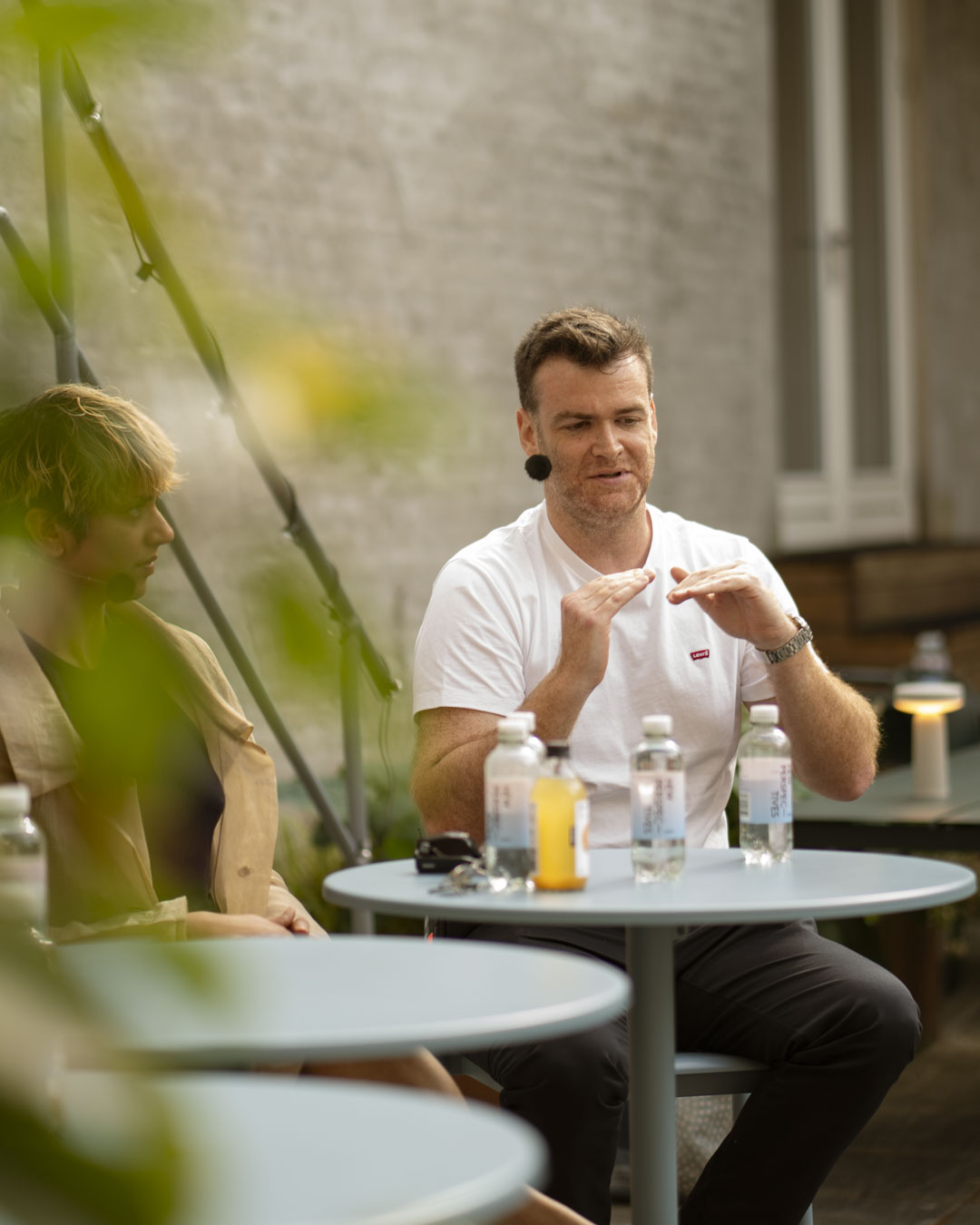 Close-up of speaker during Muuto’s panel talk, captured in a modern outdoor setting