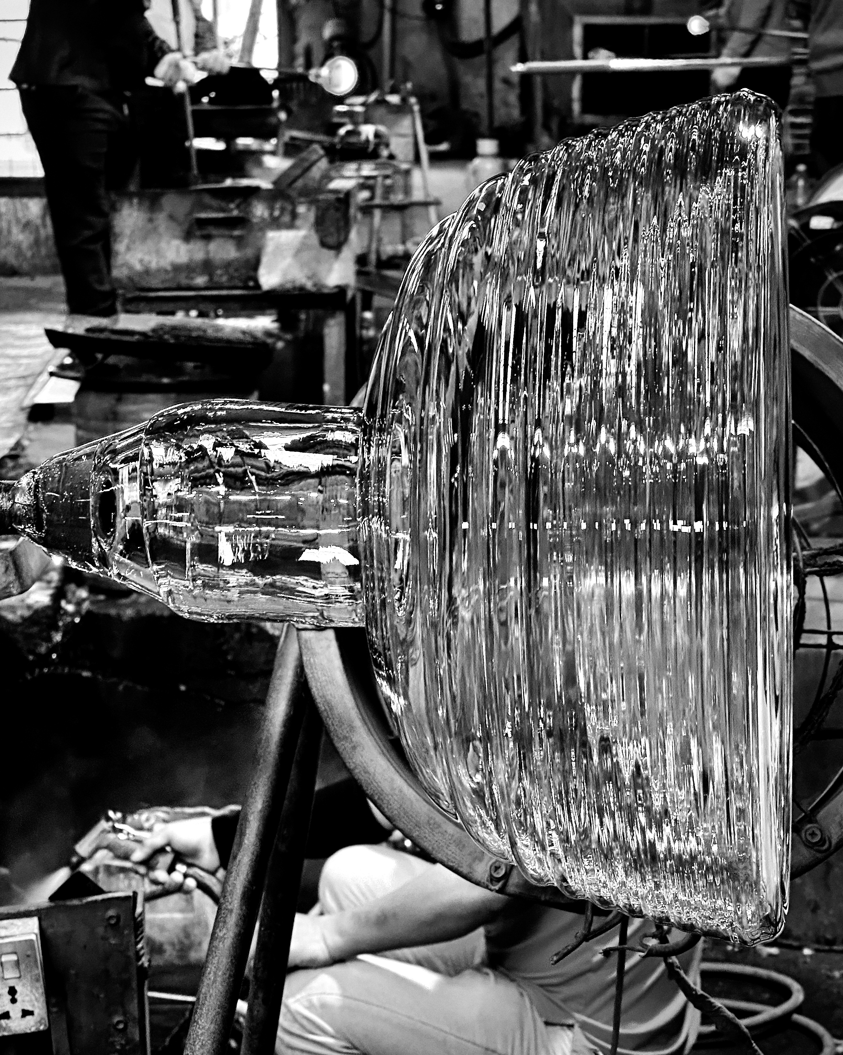 A piece of glass in the process of being blown in a mold.