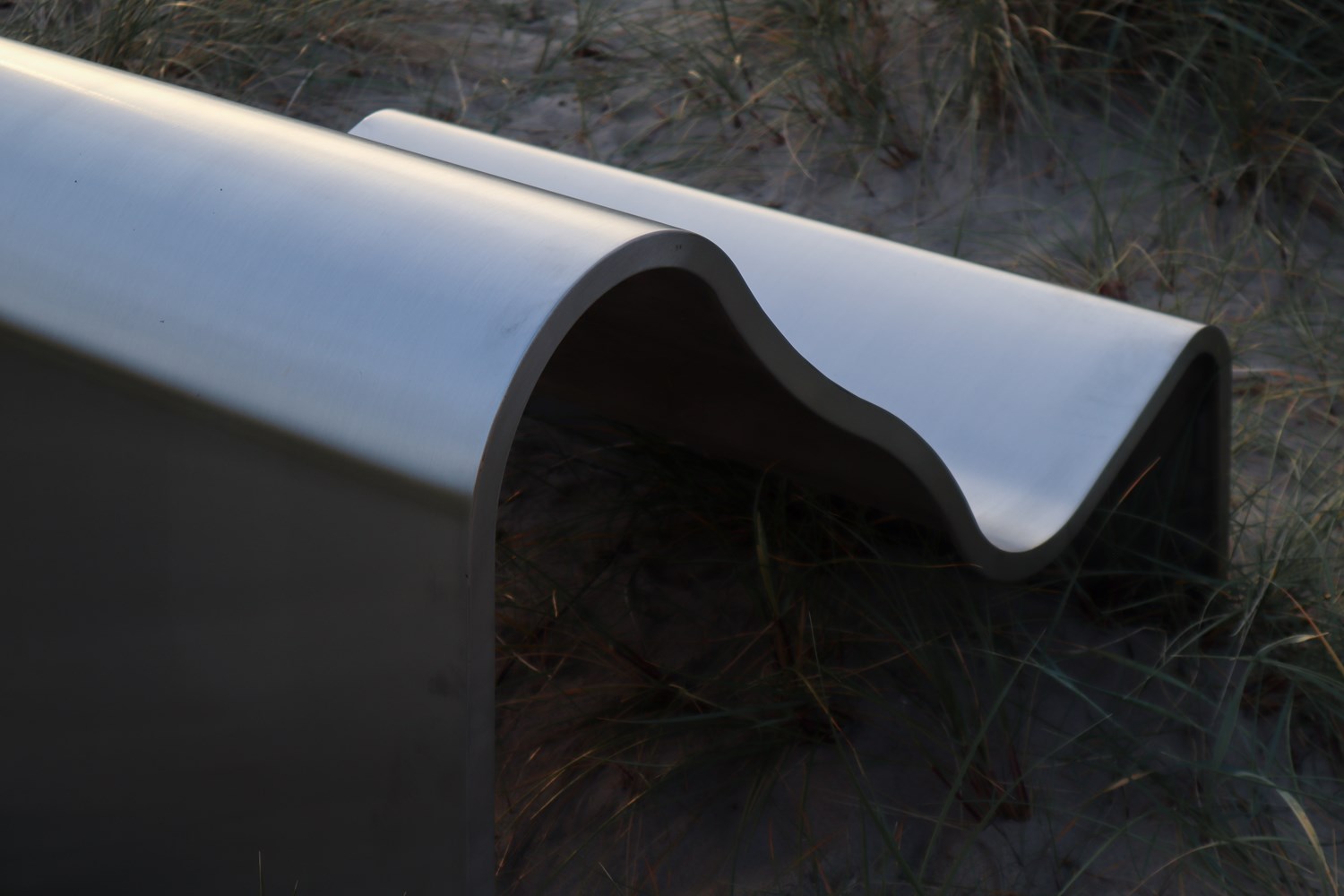 A close-up of the Dream View Chair showcases its curved design, which adds a soft, elegant touch to the modern steel frame. A close-up of the Dream View Chair showcases its curved design, which adds a soft, elegant touch to the modern steel frame.