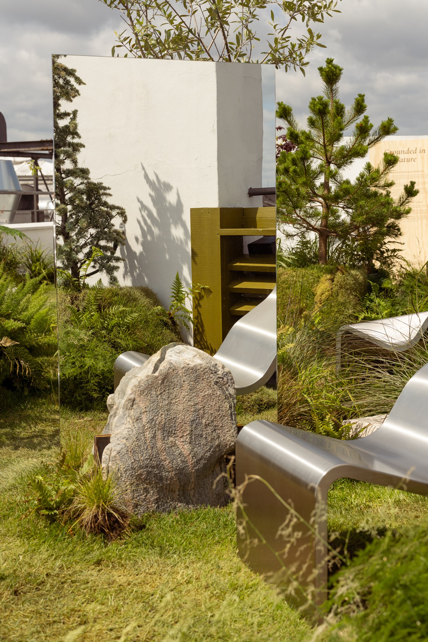 An image of the Dream View Chair placed on a rooftop surrounded by lush green plants and grass, creating a serene and calming atmosphere. An image of the Dream View Chair placed on a rooftop surrounded by lush green plants and grass, creating a serene and calming atmosphere.