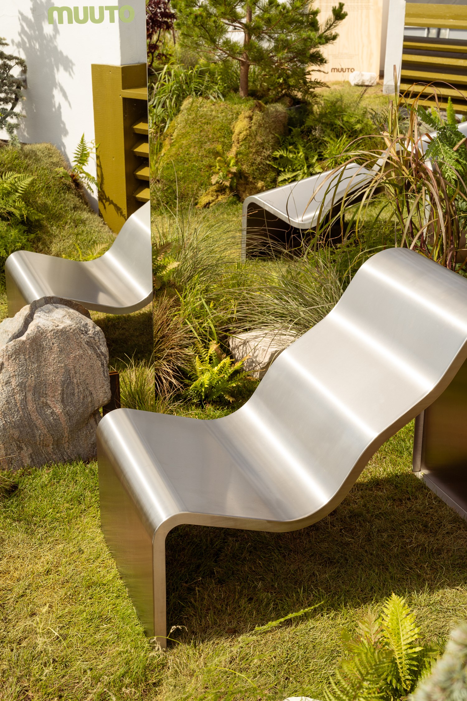 The Dream View Chair is placed on green grass, surrounded by lush plants. A nearby mirror reflects the chair, adding an intriguing touch to the outdoor arrangement. The Dream View Chair is placed on green grass, surrounded by lush plants. A nearby mirror reflects the chair, adding an intriguing touch to the outdoor arrangement.