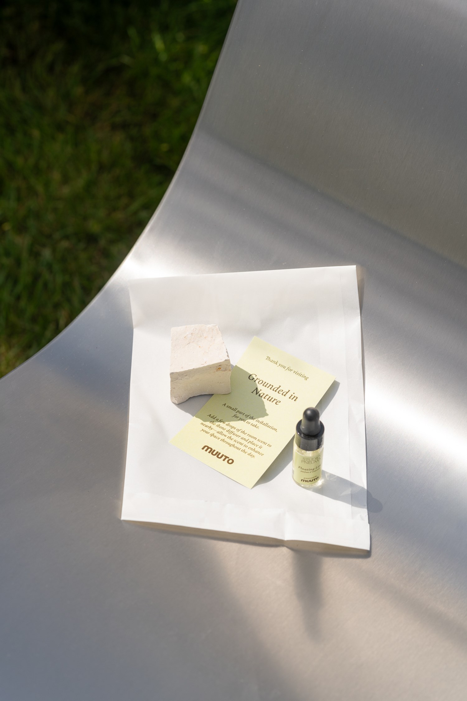 A small bottle with Muuto's own scent placed on a Dream View Chair A small bottle with Muuto's own scent placed on a Dream View Chair
