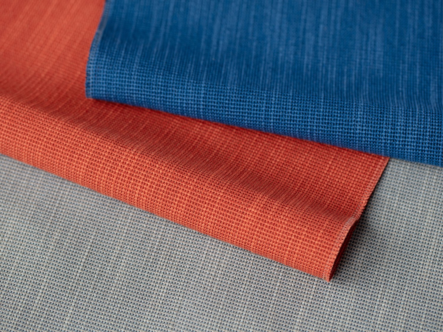 Close-up of overlapping blue and red textiles, emphasizing their distinct textures and vibrant colors. Close-up of overlapping blue and red textiles, emphasizing their distinct textures and vibrant colors.