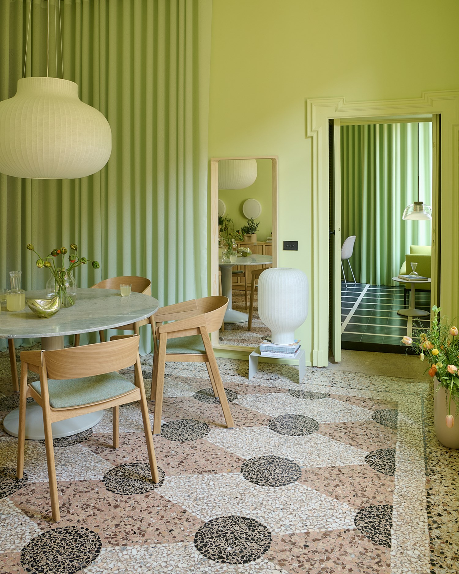 Image of Muuto's Milan Apartment. A ligtht green room with wooden chairs and white lamps.  Image of Muuto's Milan Apartment. A ligtht green room with wooden chairs and white lamps.