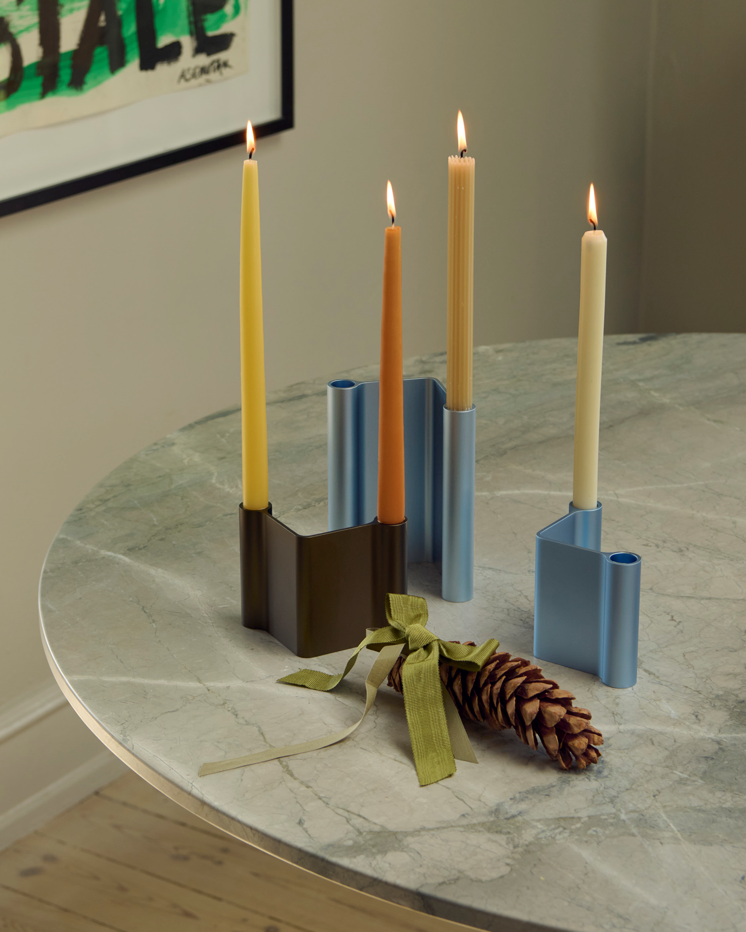 Midst Table with brown and light blue Pair Candleholders in a festive setting. The Midst Table in grey marble styled with Pair Candleholders in brown and light blue, creating a calm atmosphere with subtle color contrasts and minimalist details.