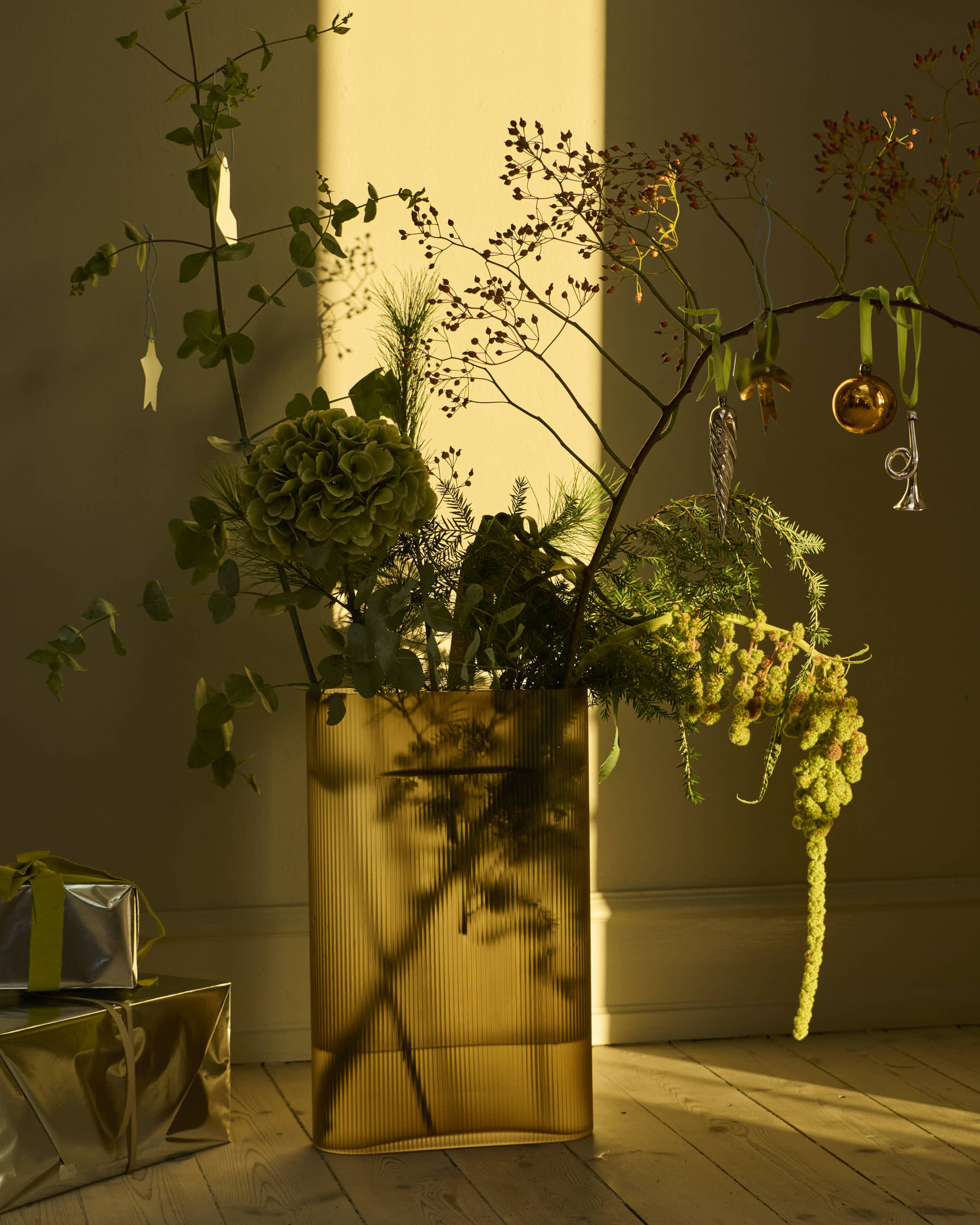 The Ridge Vase frosted glass in taupe, in a softly styled holiday setting with warm tones and seasonal details.