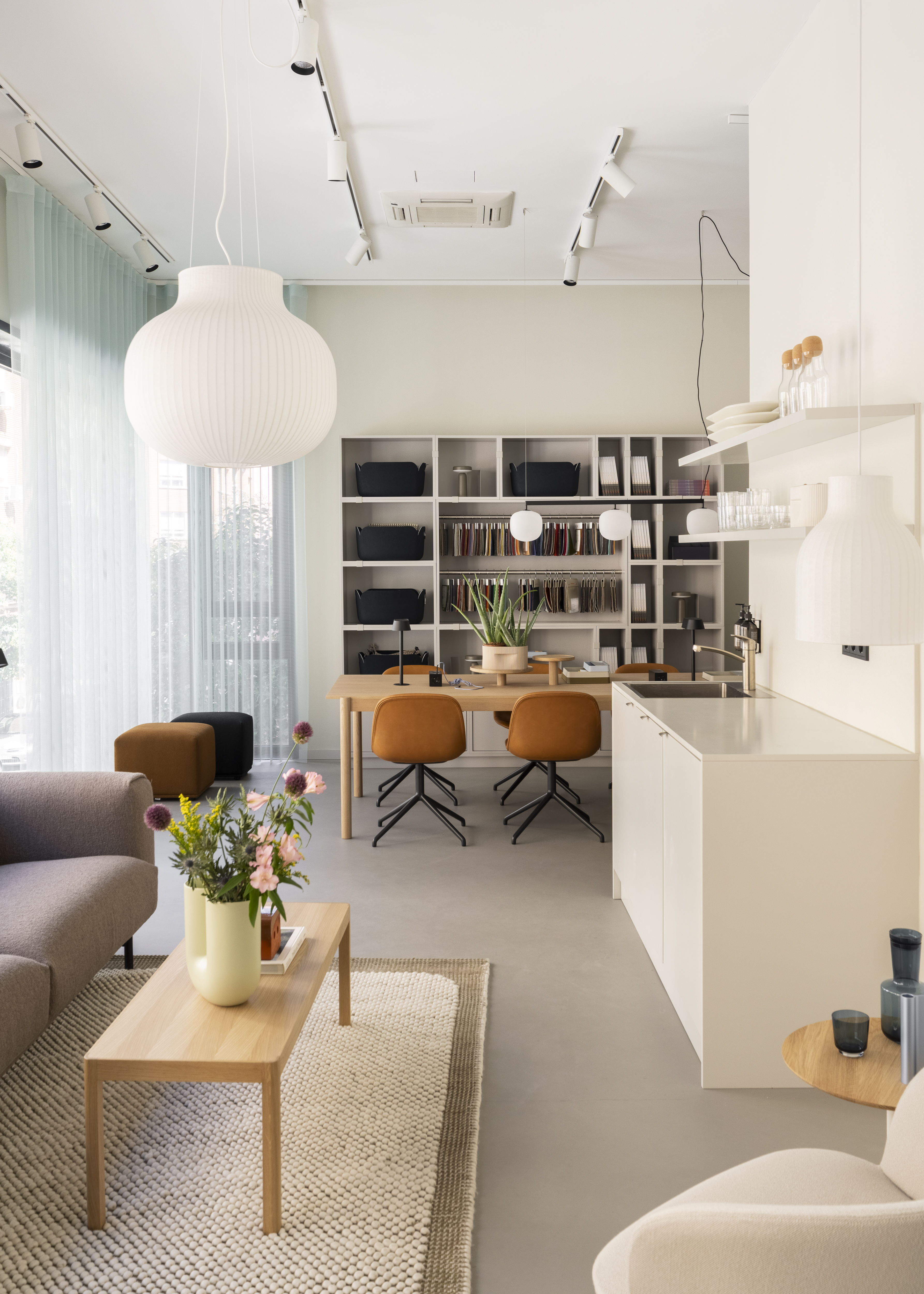 View of the Muuto Madrid showroom featuring contemporary furniture, lighting, and accessories arranged in a bright, minimalist space with soft colors and natural materials.