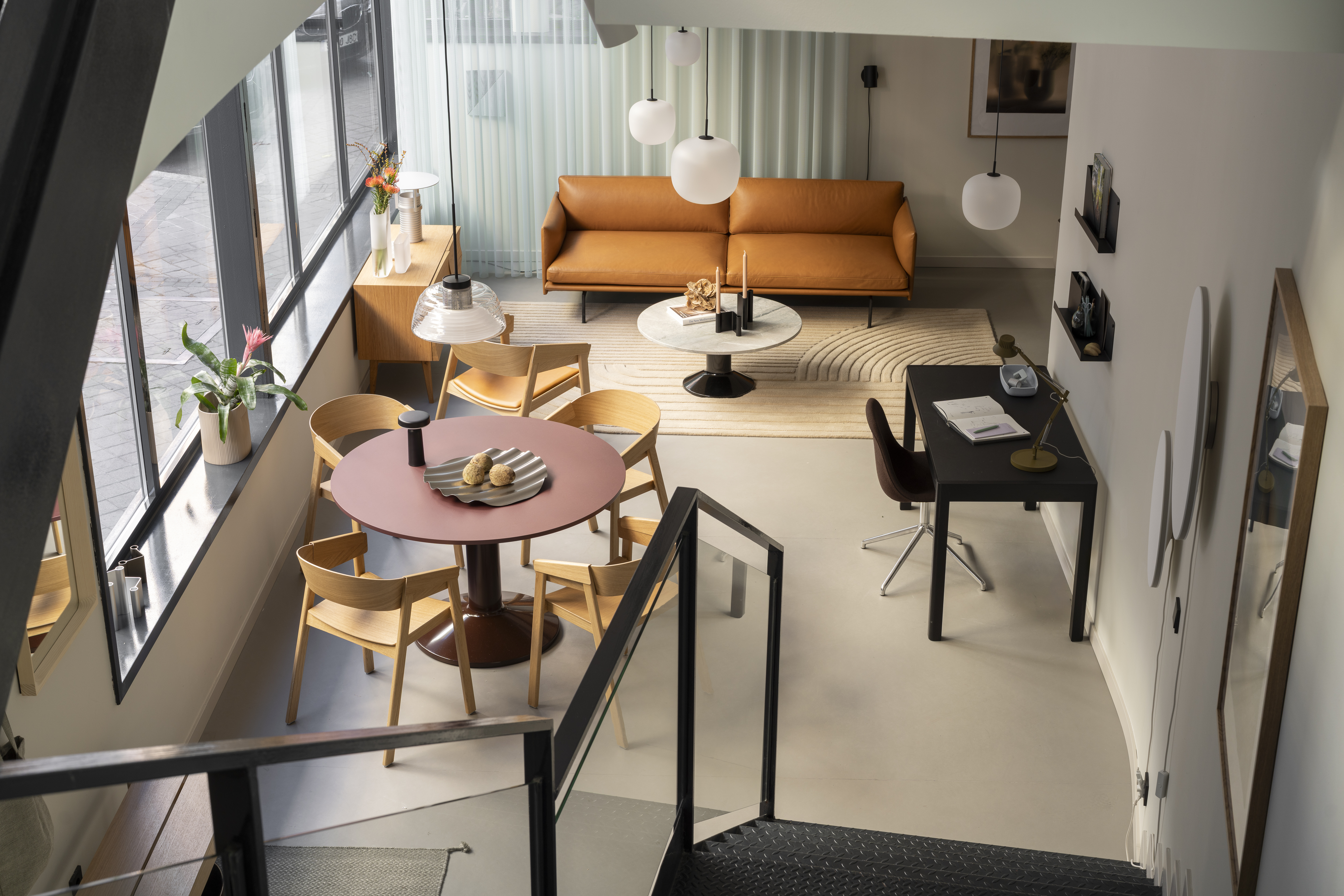 A balanced interior from the Muuto showroom in Madrid, showcasing modern furniture and lighting arranged with clean lines, soft tones, and thoughtful composition.